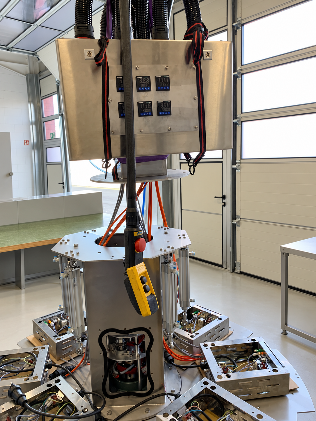 Special machine for food industry during assembly phase with component suspended to workshop crane.